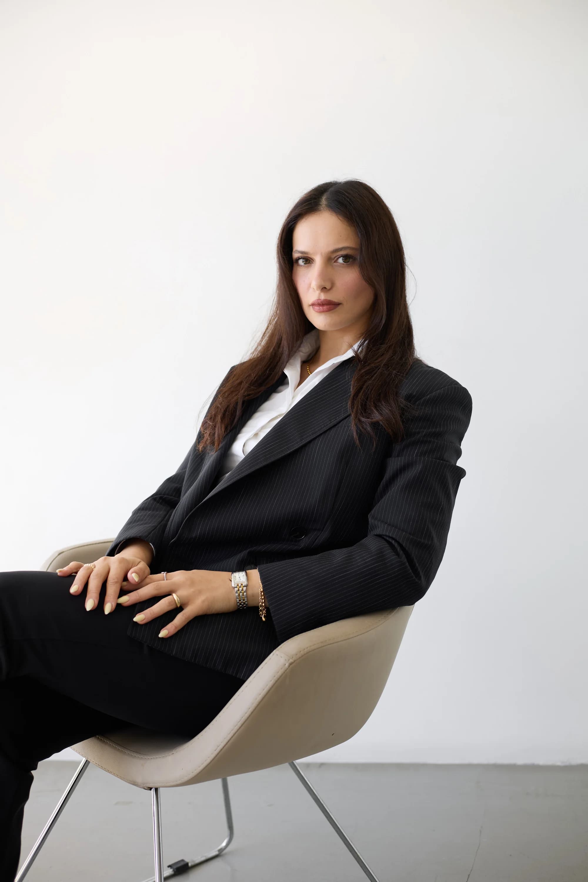 Nura Issa in a thoughtful pose, founder of NURA AURA